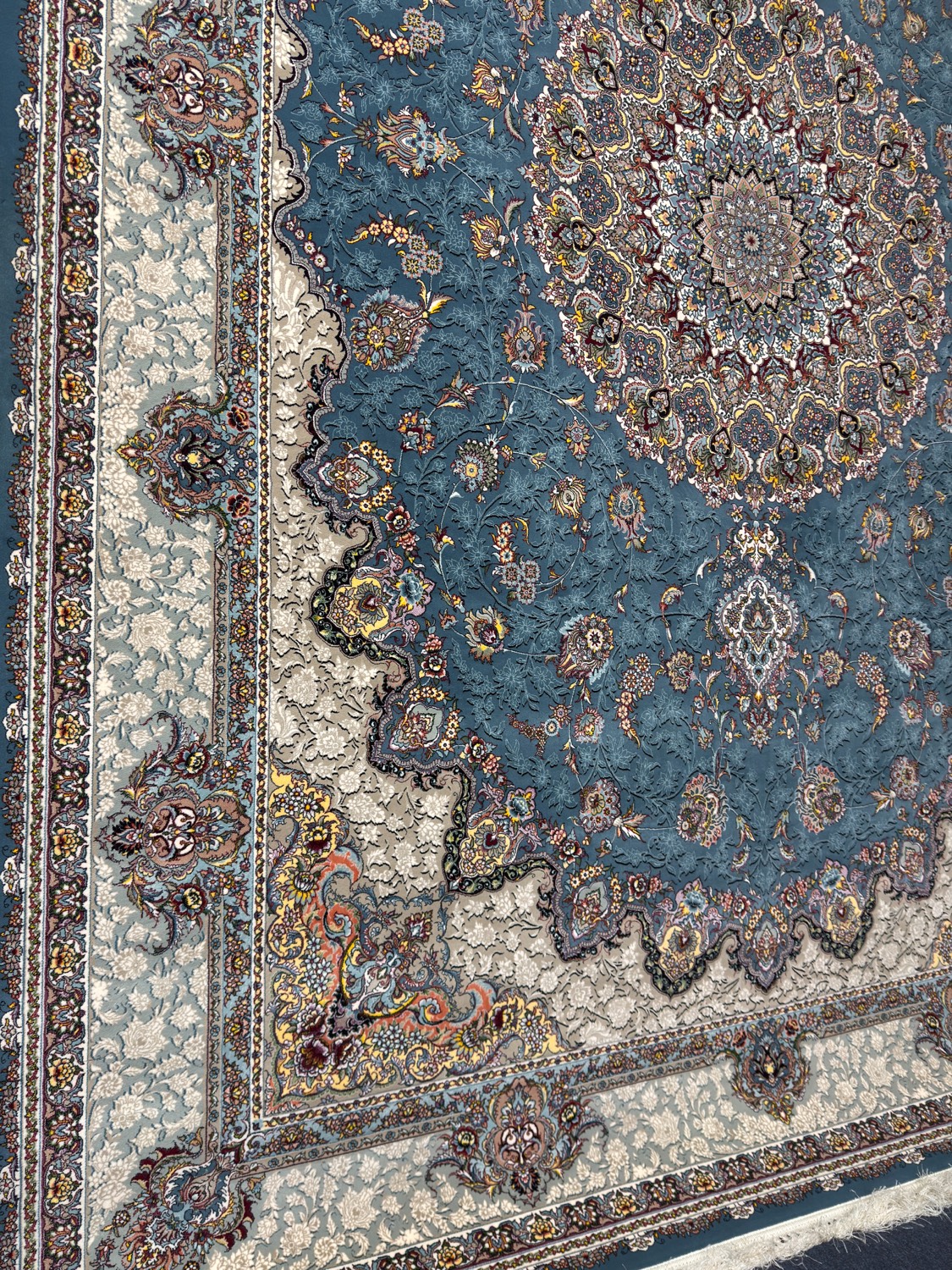 Persian rug with blue floral medallion, showroom hero shot