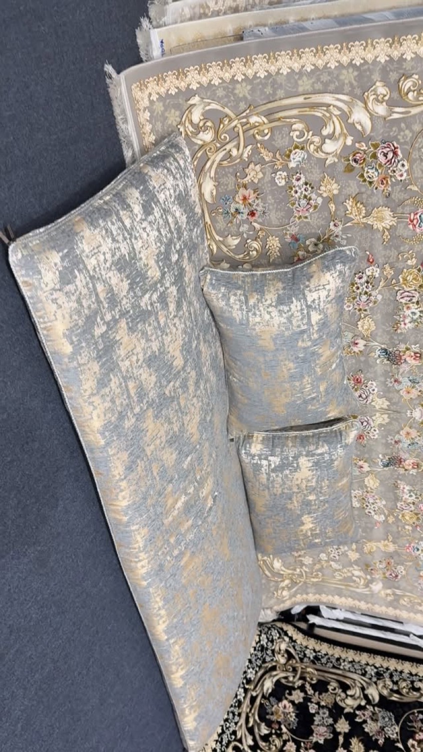 Velvet toshak cushions in blue and gold resting on ornate rugs
